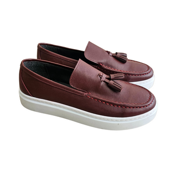 Pair of children’s maroon loafers with decorative tassels, red stitching detail, and thick white rubber soles, in smart style.
