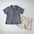 Flat lay of a stylish toddler outfit featuring a ribbed, short-sleeve navy blue polo shirt with a single button, paired with cream drawstring shorts.
