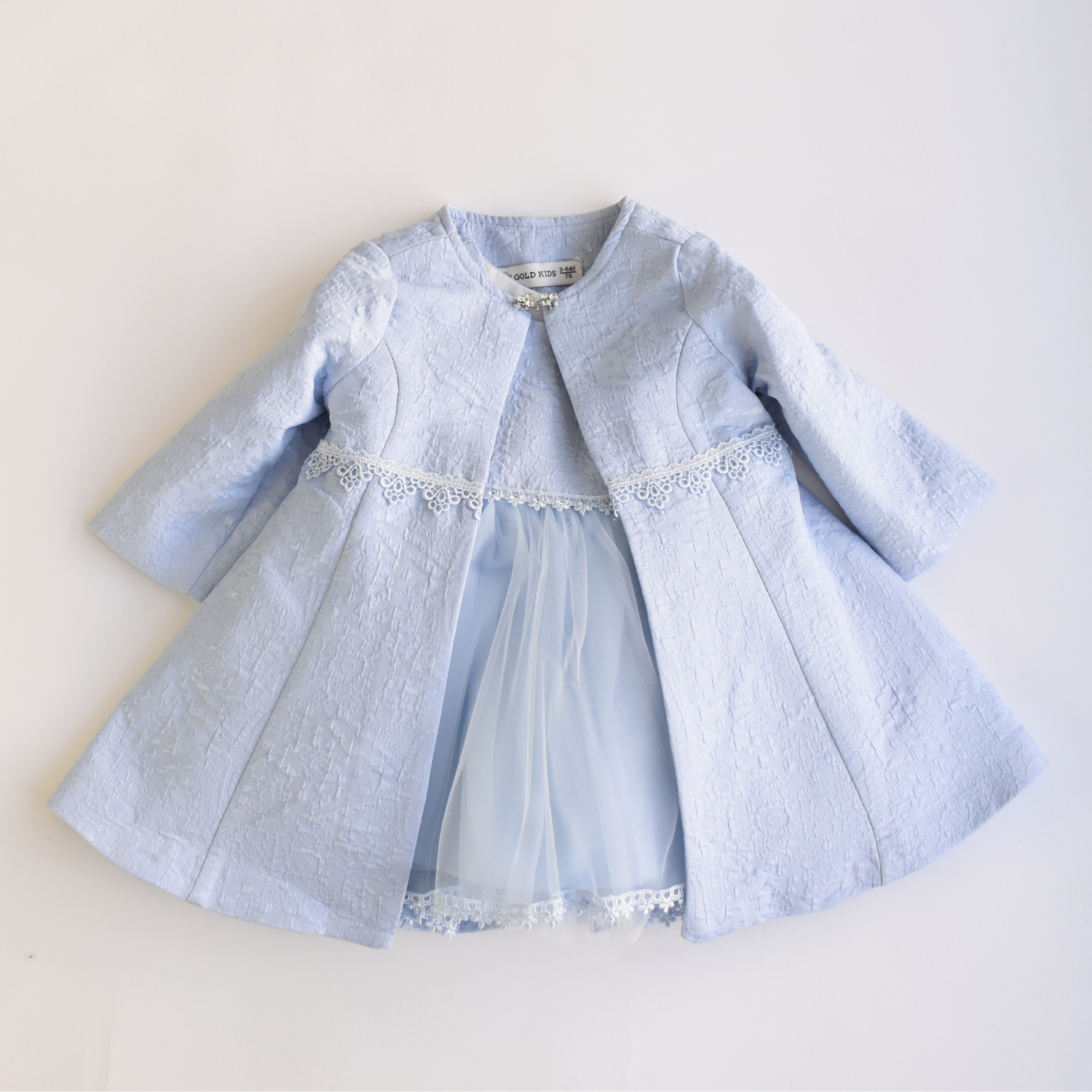 Light blue girls’ formal coat with textured fabric, lace trim at the waist, and sheer tulle dress peeking underneath, ideal for special occasions.
