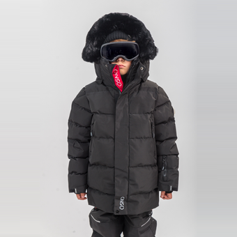 Child wearing a black winter coat with fur hood and goggles on a white background