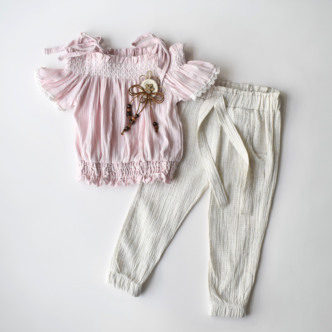 Girls outfit with pink off-shoulder top and white elastic waist pants