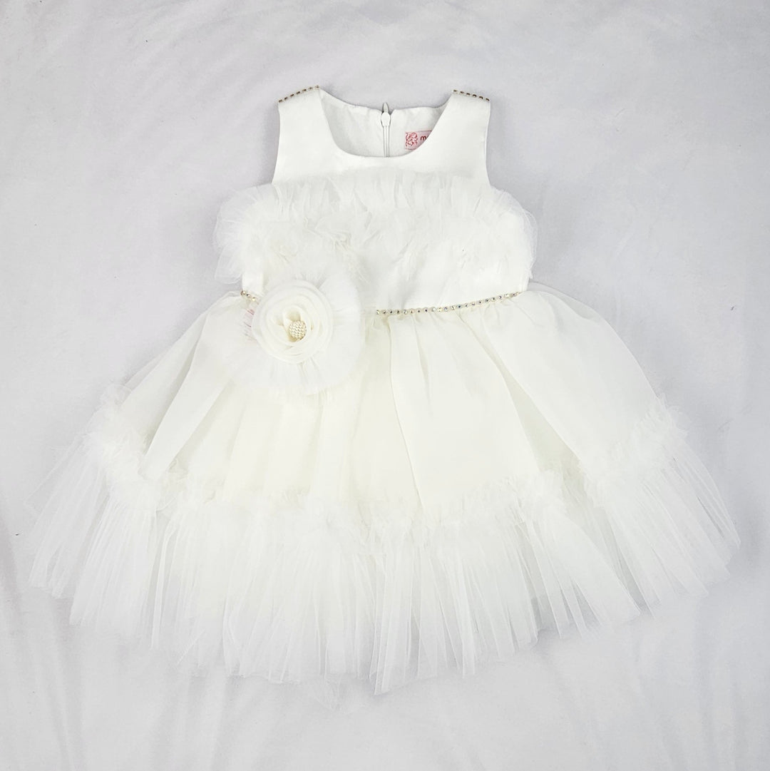 White baby girl tulle dress with layered skirt, floral waist detail and soft sleeveless bodice displayed on a white background.