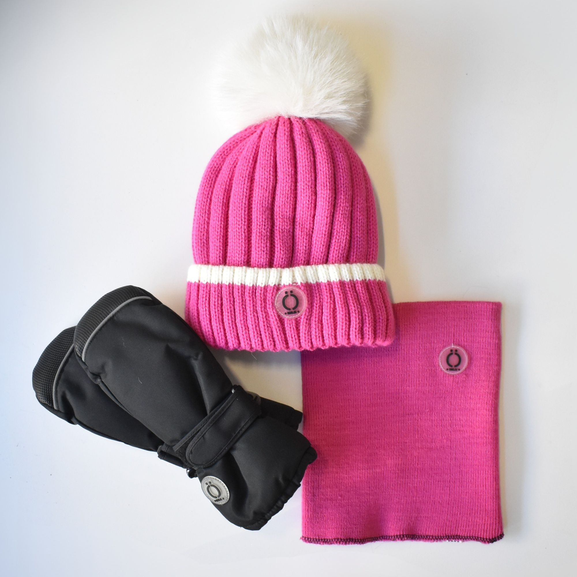 Three-piece kids’ winter set featuring a hot pink knit beanie with a fluffy white pom-pom, matching neck warmer, and black insulated mittens.