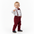 Child wearing a formal outfit with a white shirt, red bow tie, suspenders, and red pants on a white background