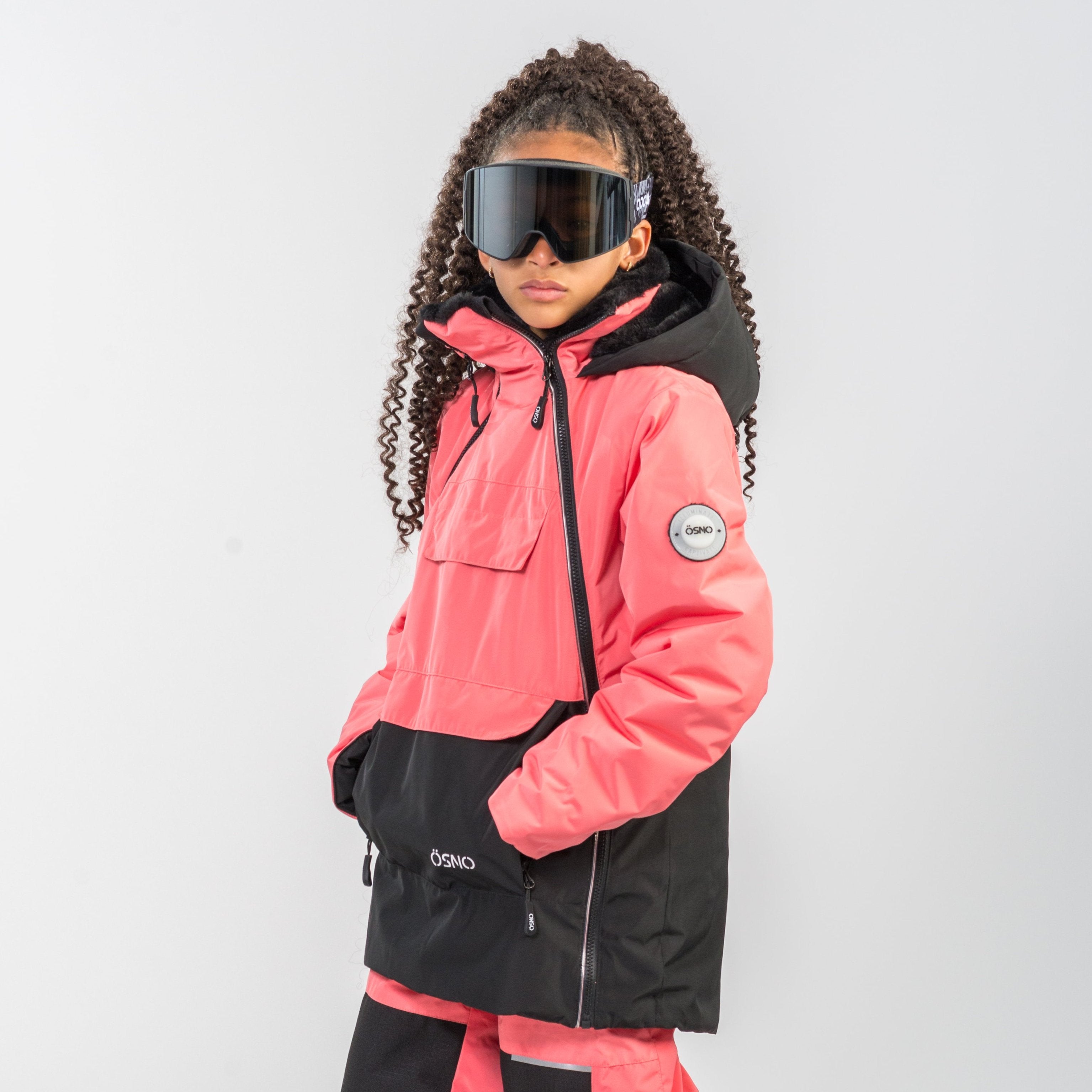 Eva's Performance girls snowsuit in coral with stylish details by Junior Kids